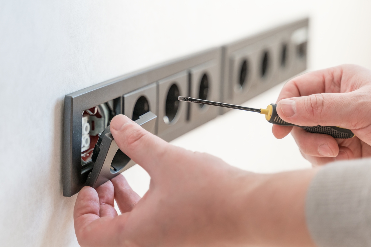 A man installing a home's electrical outlet